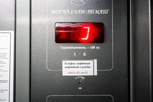 a close up of a machine with a red clock
