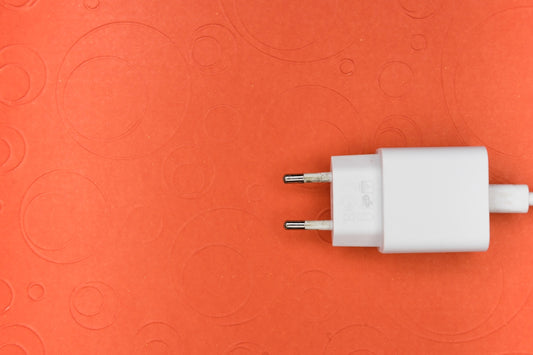 white adapter on pink surface
