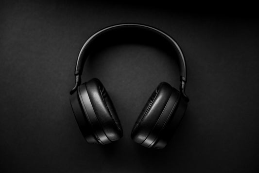 black wireless headphones on black surface