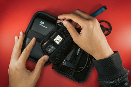 a person holding a cell phone in a case