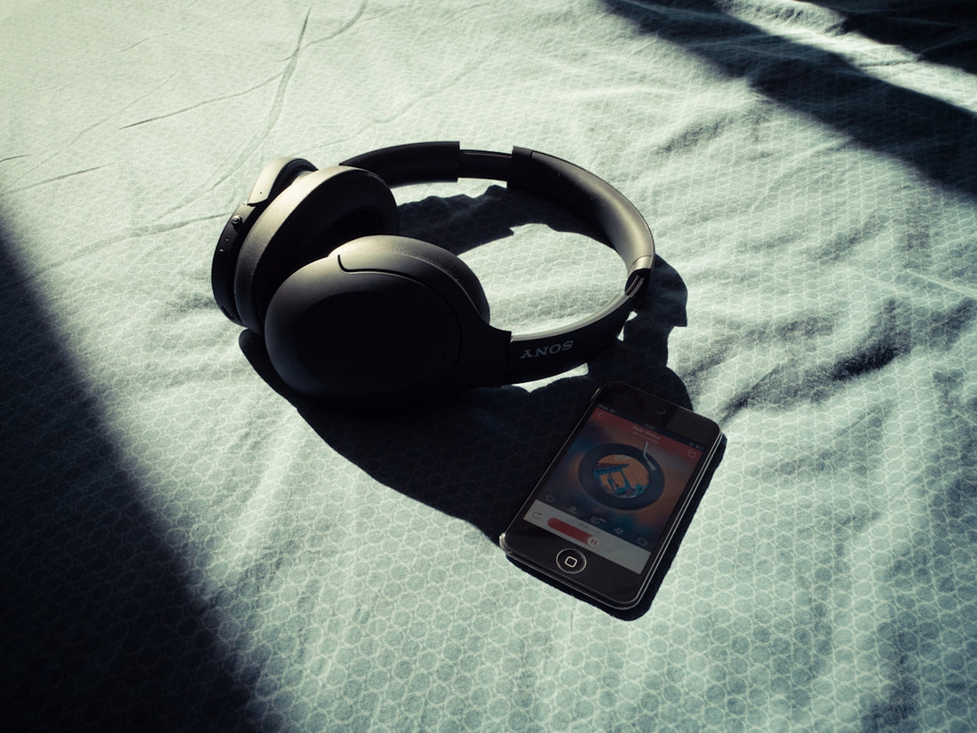 a pair of headphones sitting on top of a bed