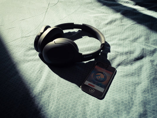 a pair of headphones sitting on top of a bed