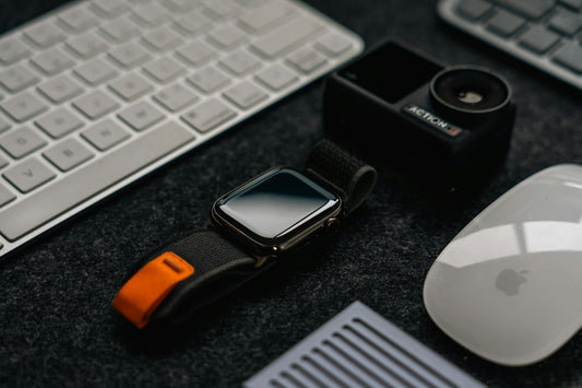 a cell phone, mouse, and keyboard on a desk
