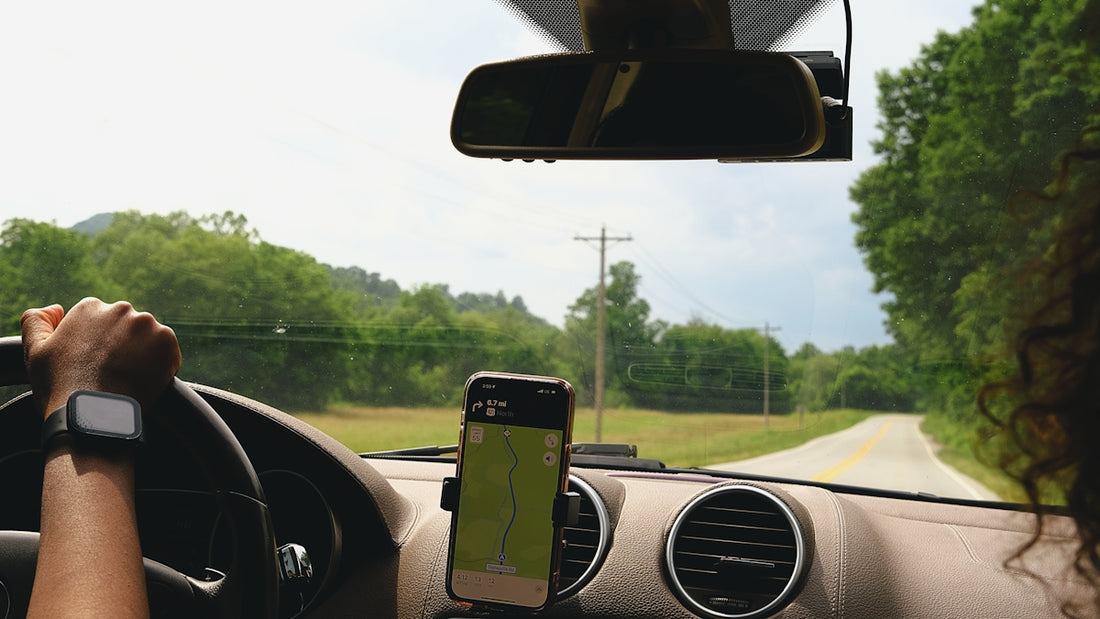 a woman driving a car with a cell phone in her hand