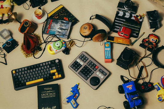 A table topped with lots of toys and electronics